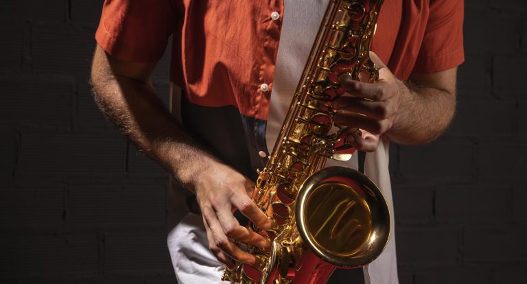 Músico tocando el saxofón bajo luz tenue
